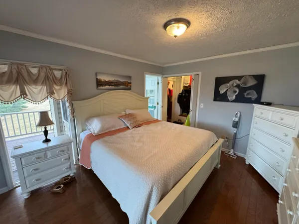 a kitchen with granite countertop a stove a sink and a white cabinets