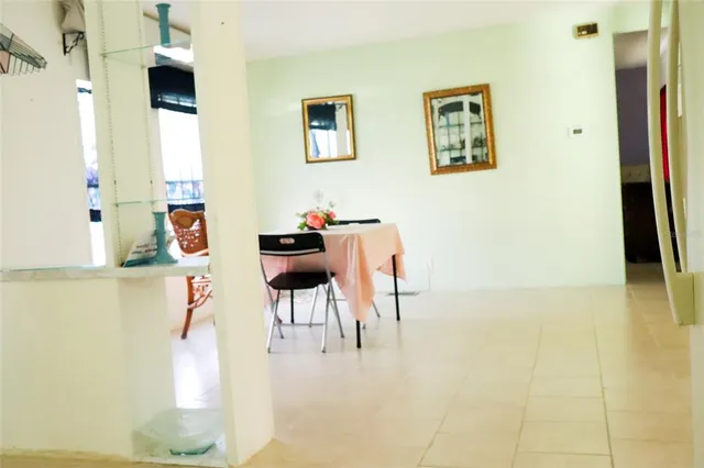 a dining room with furniture and a kitchen view
