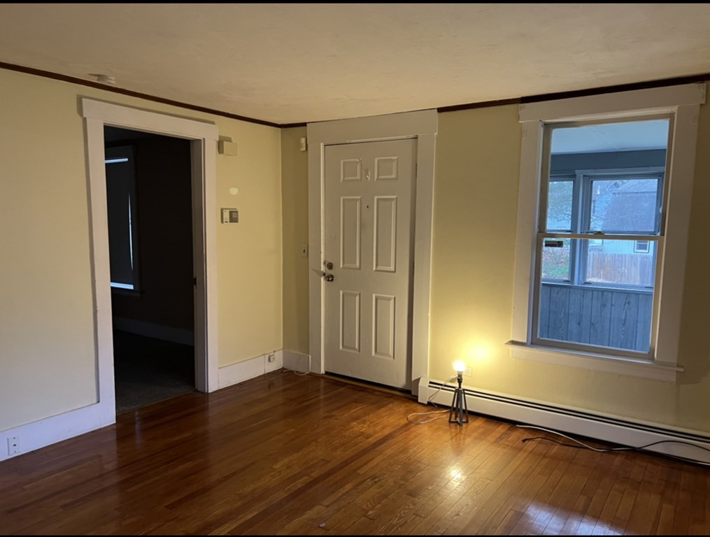 37 Harding Street North Chelmsford, MA 01863 - Photo 5 of 10 an empty room with wooden floor and windows