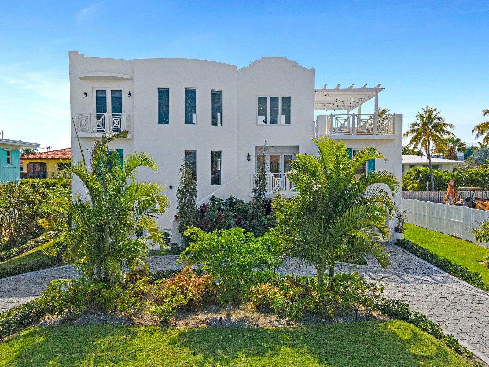 317 East Seaview Circle Marathon, FL 33050 - Photo 1 of 52 a front view of a house with a garden