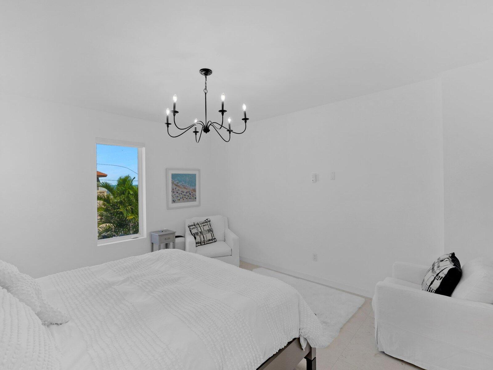 317 East Seaview Circle Marathon, FL 33050 - Photo 25 of 52 a bedroom with a bed and a chandelier