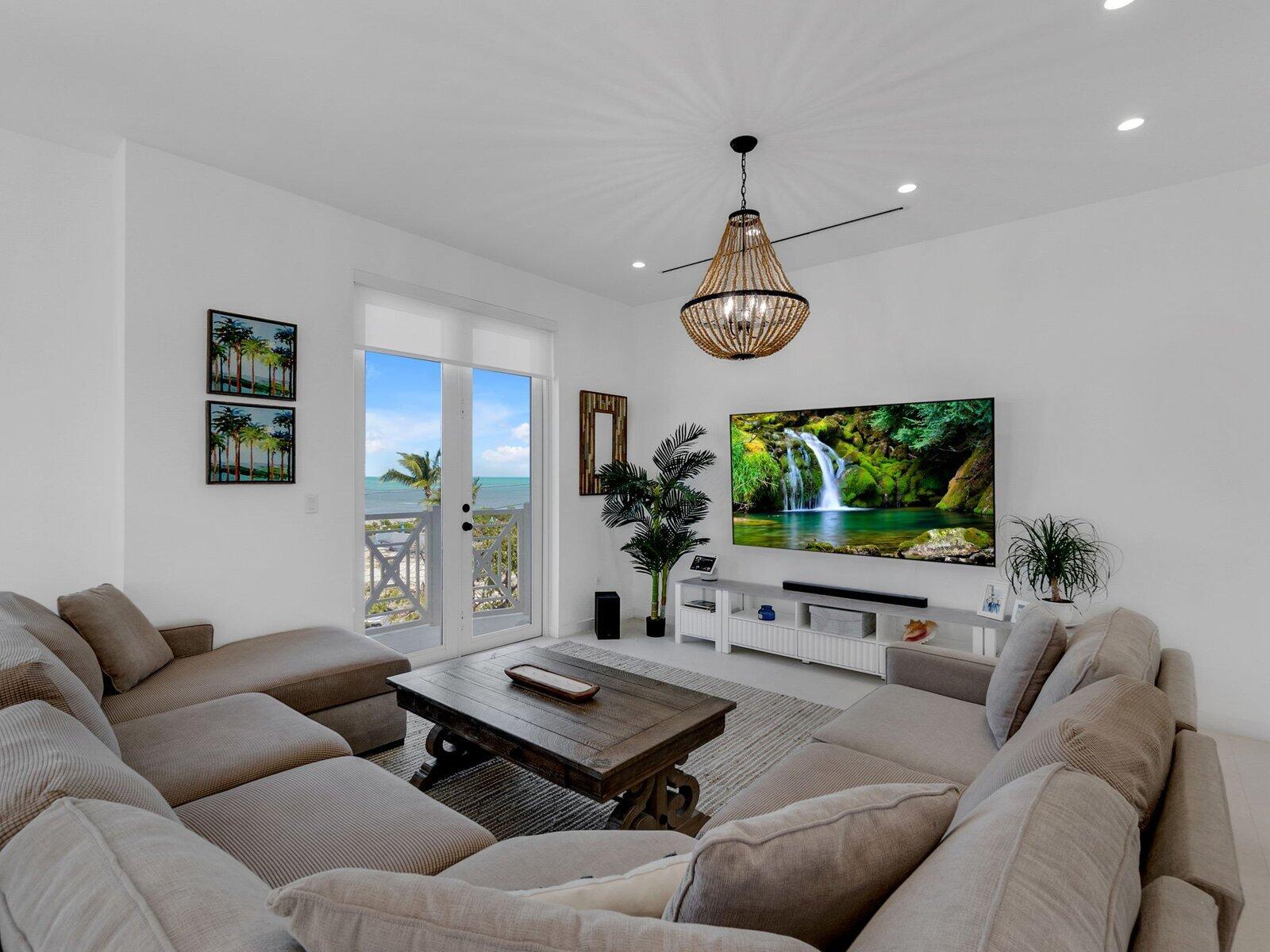 317 East Seaview Circle Marathon, FL 33050 - Photo 29 of 52 a living room with furniture a window and a flat screen tv