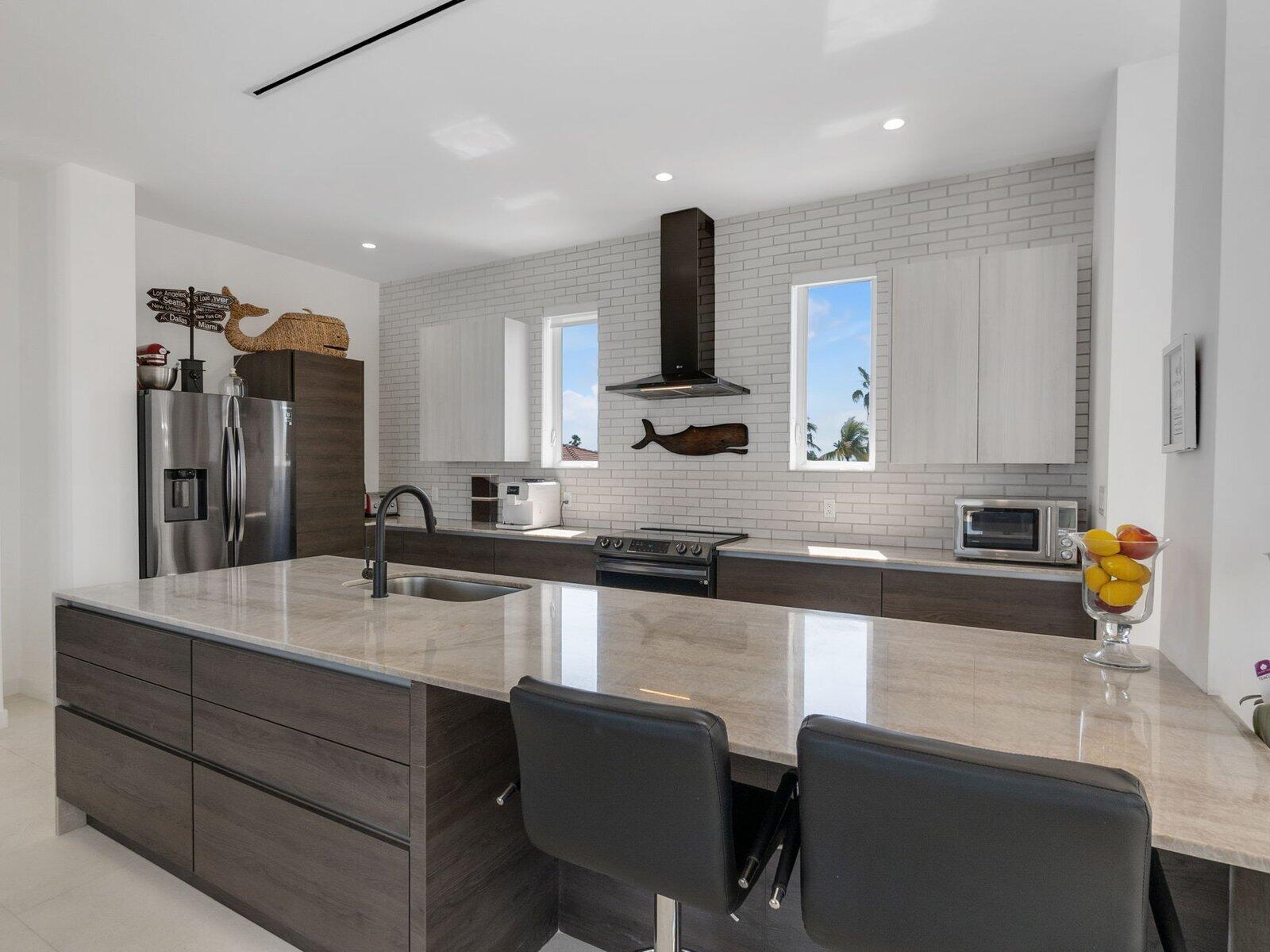 317 East Seaview Circle Marathon, FL 33050 - Photo 31 of 52 a kitchen with stainless steel appliances granite countertop a sink and a refrigerator