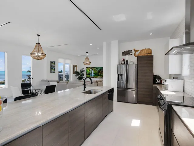 a kitchen with stainless steel appliances a sink and a refrigerator