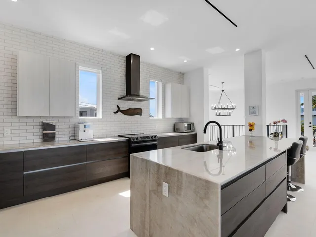 a kitchen with a sink appliances and cabinets