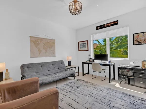 a living room with furniture a large window and a table