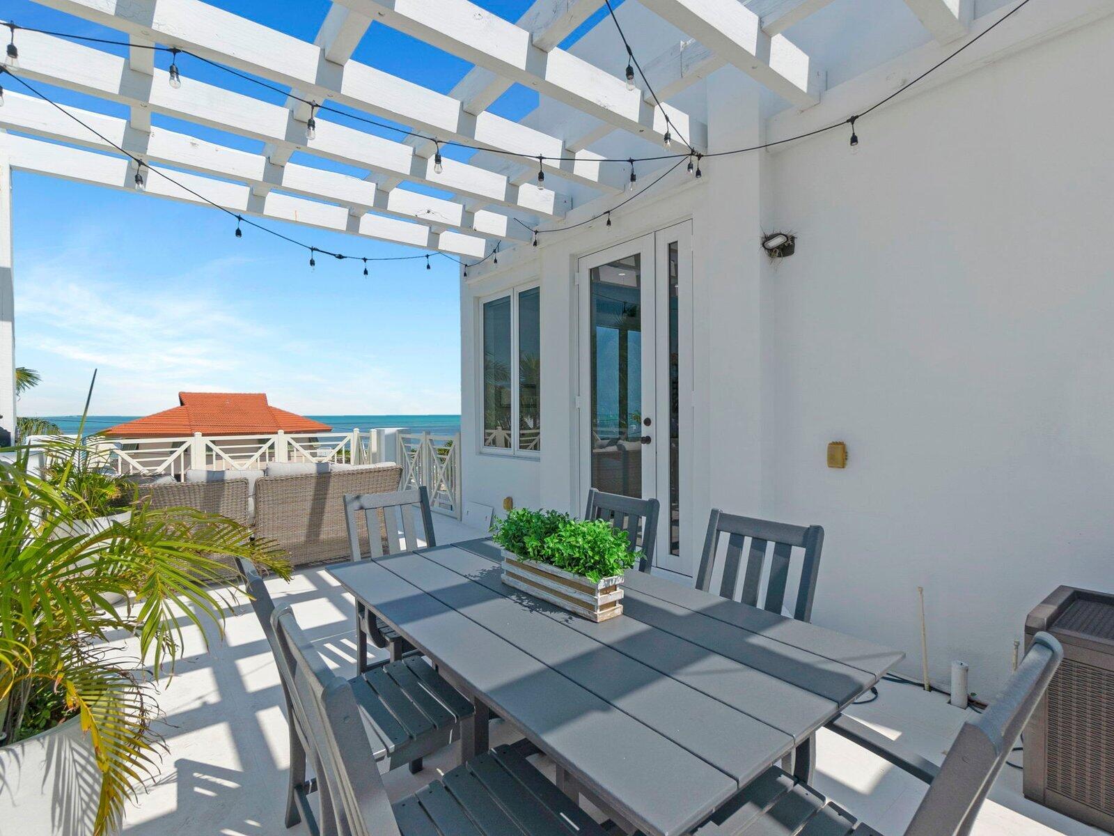317 East Seaview Circle Marathon, FL 33050 - Photo 41 of 52 a view of a patio with table and chairs with wooden floor