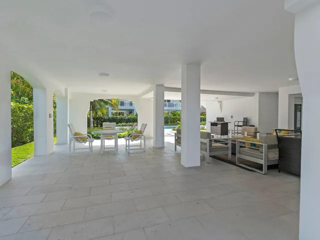 a swimming pool with outdoor seating and yard