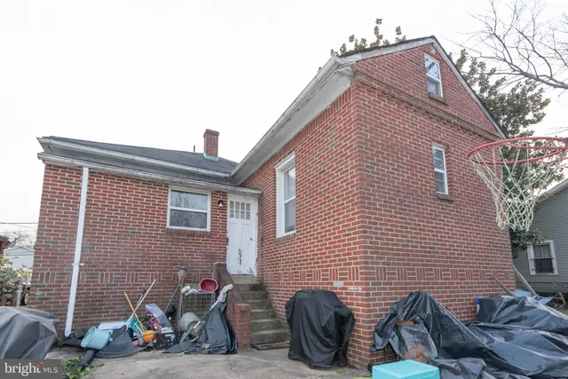 a view of a house with a patio and a yard