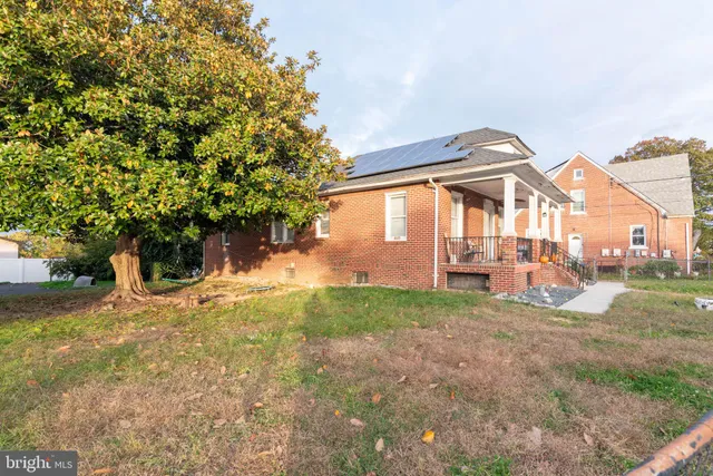 a view of a house with backyard porch and sitting area
