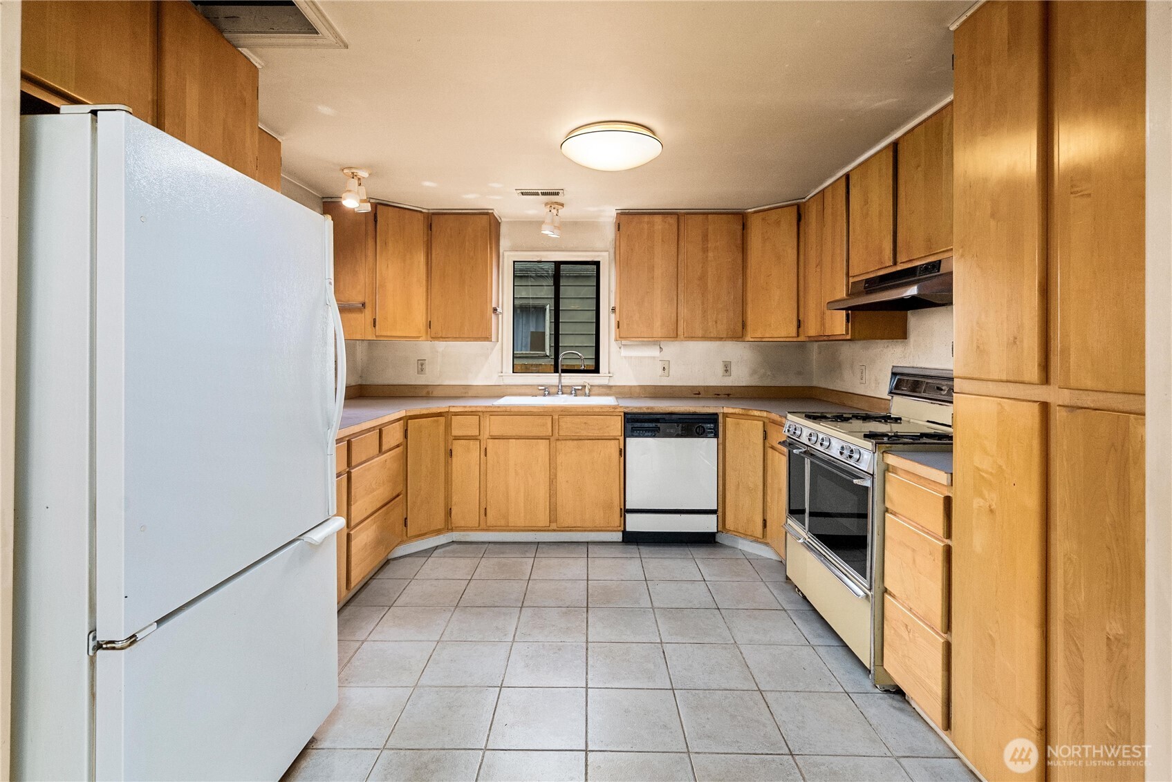 1230 South Donovan Street Seattle, WA 98108 - Photo 12 of 34 a kitchen with a stove sink and cabinets