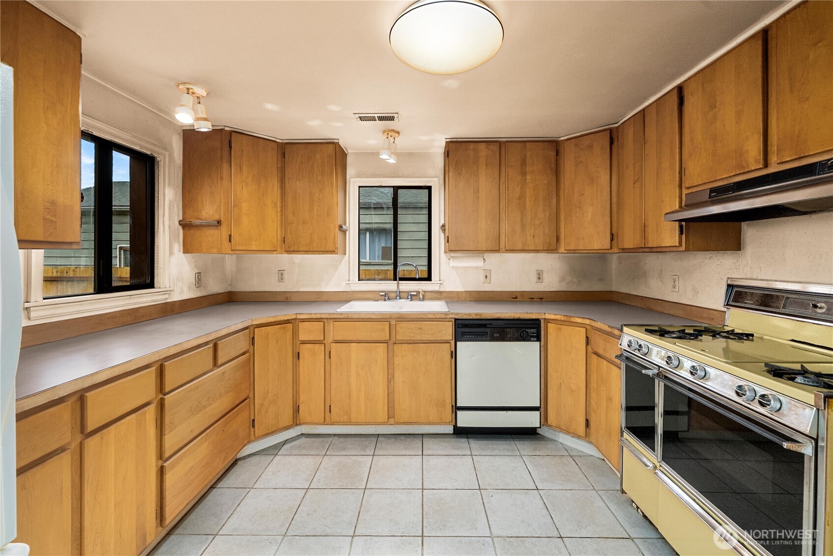 1230 South Donovan Street Seattle, WA 98108 - Photo 13 of 34 a kitchen with a sink stove and cabinets