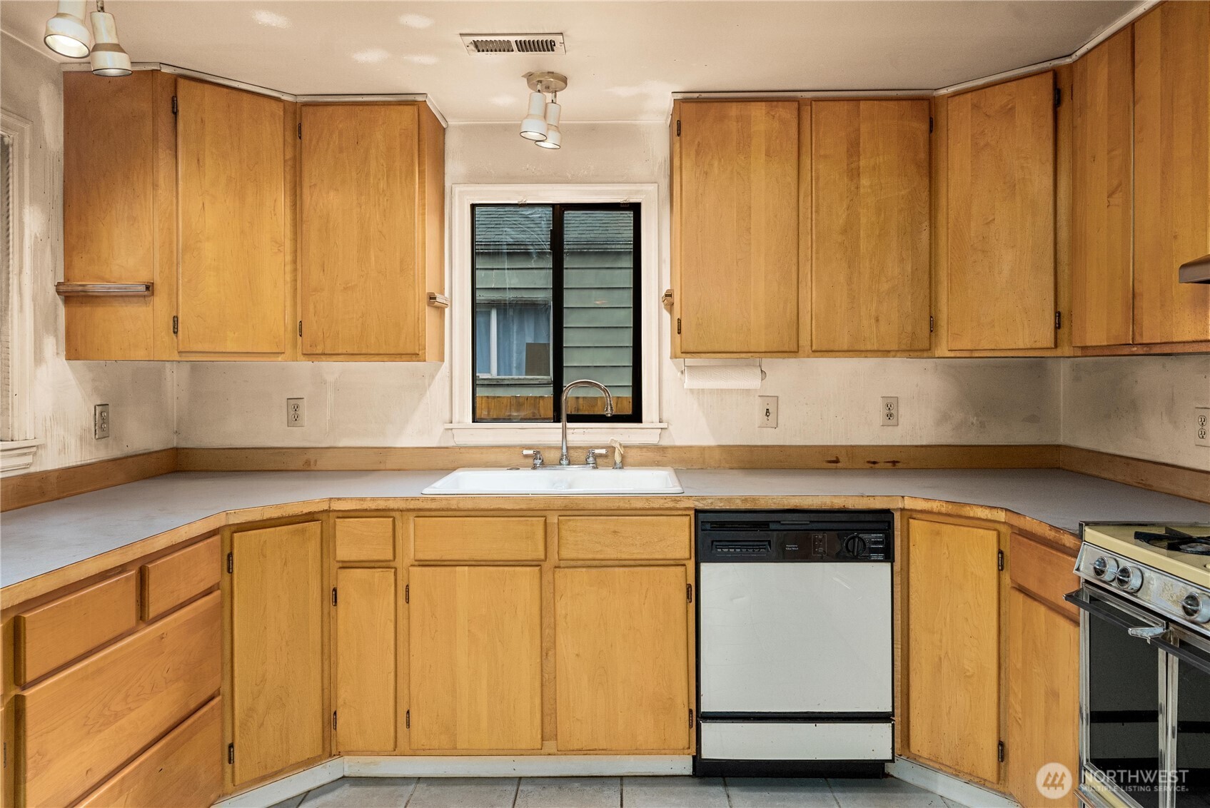 1230 South Donovan Street Seattle, WA 98108 - Photo 14 of 34 a kitchen with stainless steel appliances granite countertop a sink and a cabinets