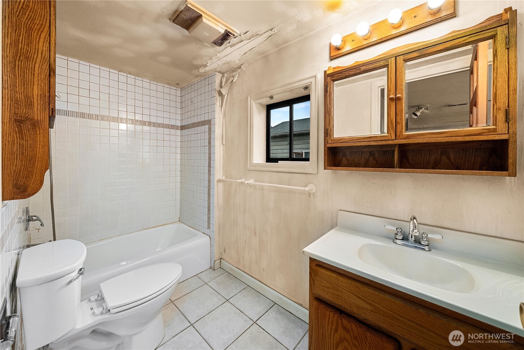 1230 South Donovan Street Seattle, WA 98108 - Photo 21 of 34 a bathroom with a sink toilet mirror and shower