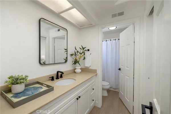 a bathroom with a granite countertop sink and a mirror