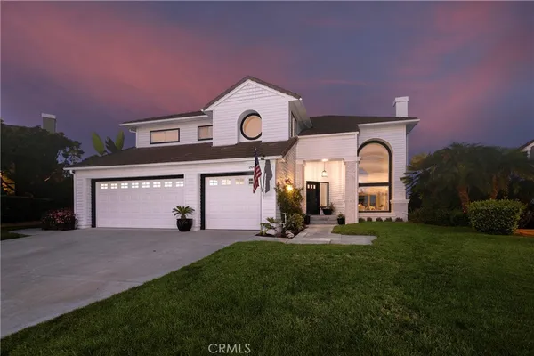 a large building with a clock on the side of it with a big yard
