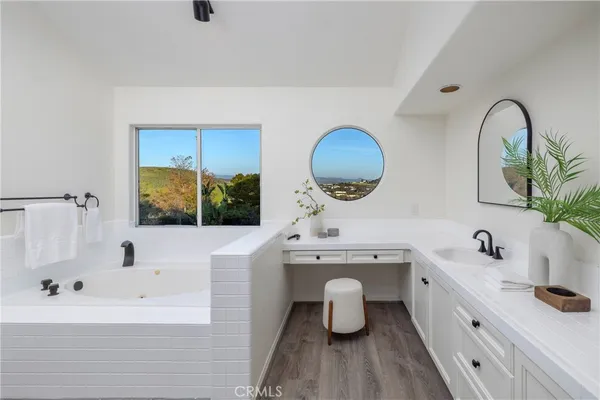 a view of bathroom with a sink and mirror