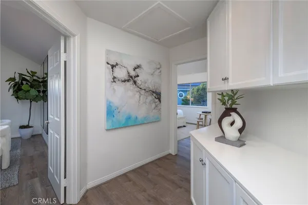 a living room with furniture a window and a potted plant
