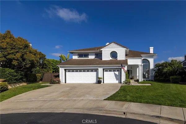 a front view of a house with a garden and a yard