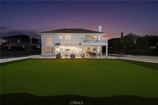 a view of a patio with a table chairs and a yard