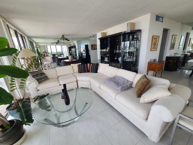 a living room with furniture and a ceiling fan