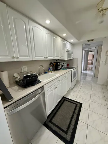 a kitchen with a sink cabinets and appliances