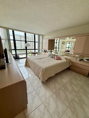 a bed room with a bed and a large window