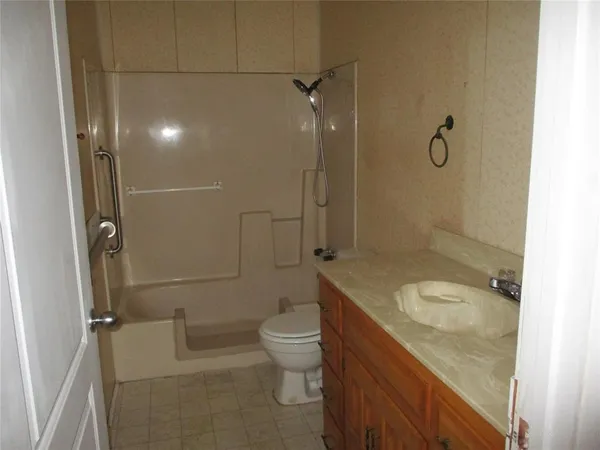 en empty room with windows and chandelier fan