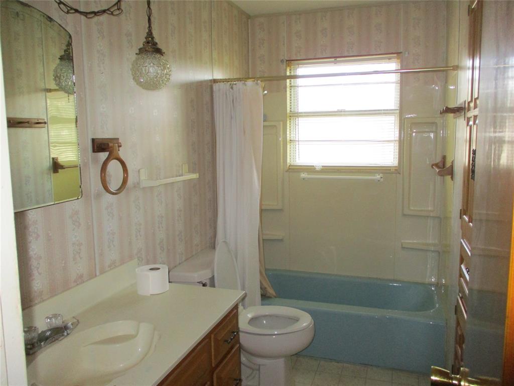 310 County Road 1495 Emory, TX 75440 - Photo 23 of 24 a bathroom with a sink toilet and shower