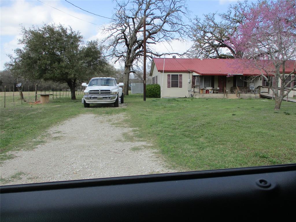 310 County Road 1495 Emory, TX 75440 - Photo 3 of 24 a front view of a house with a garden