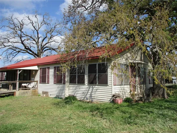 front view of a house with a tree