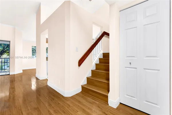 an empty room with wooden floor and window