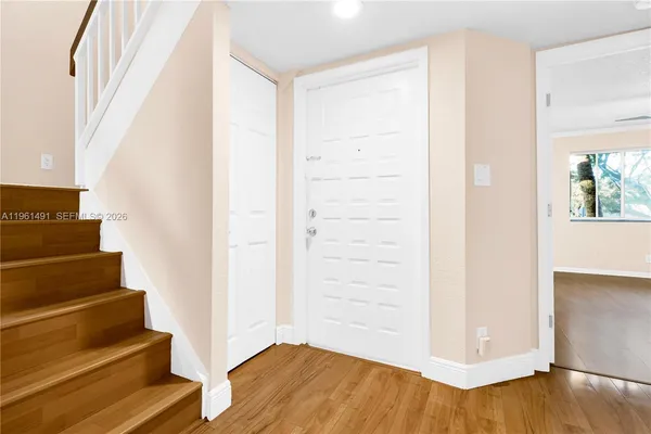a view of a room with wooden floor