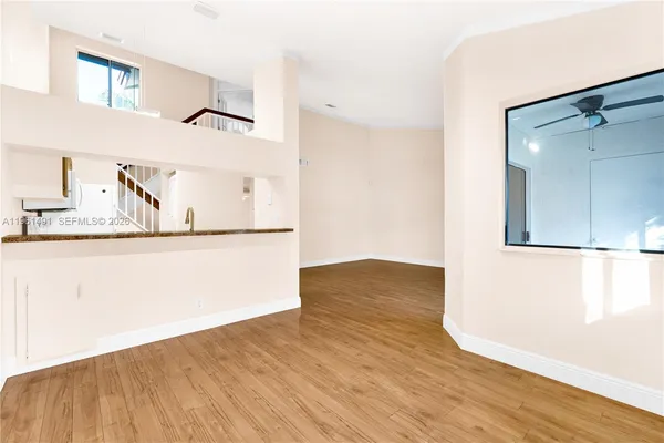 a view of a room with wooden floor and cabinet