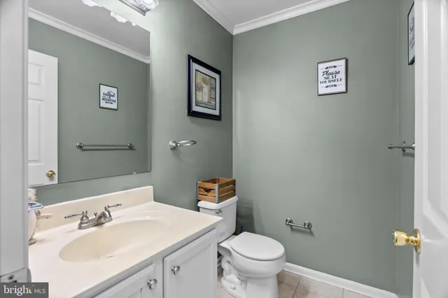a bathroom with a sink mirror vanity and toilet