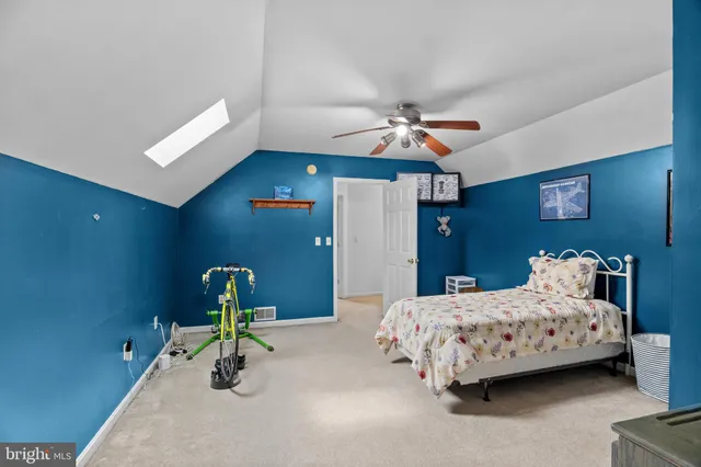 a bedroom with a bed a chandelier and closet