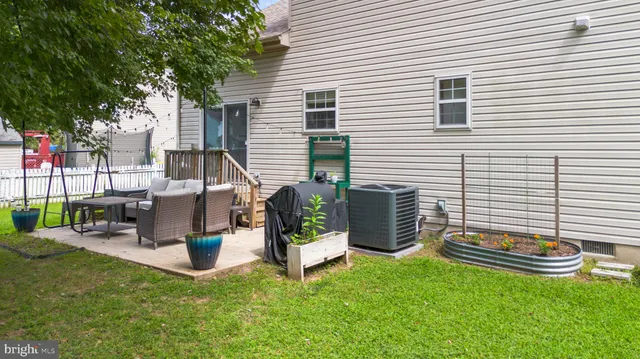 a view of a chair and tables in the backyard