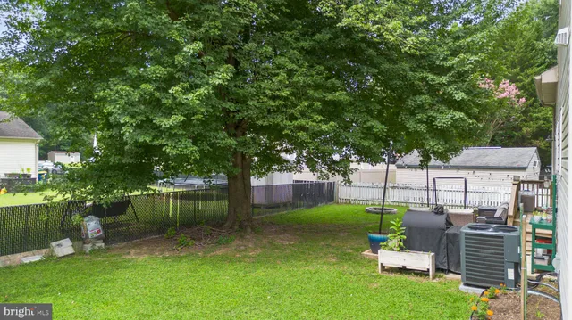 a view of a backyard with plants and a patio