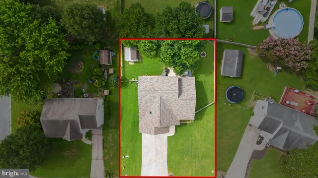 an aerial view of house with yard swimming pool and outdoor seating