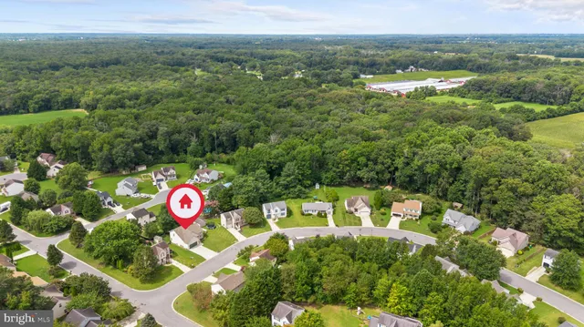 a view of small house with a yard