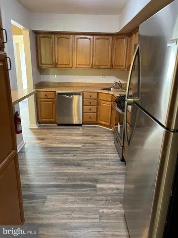 a kitchen with a refrigerator and a sink
