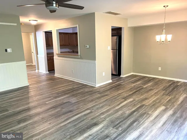 a view of a kitchen with a sink and dishwasher wooden floor