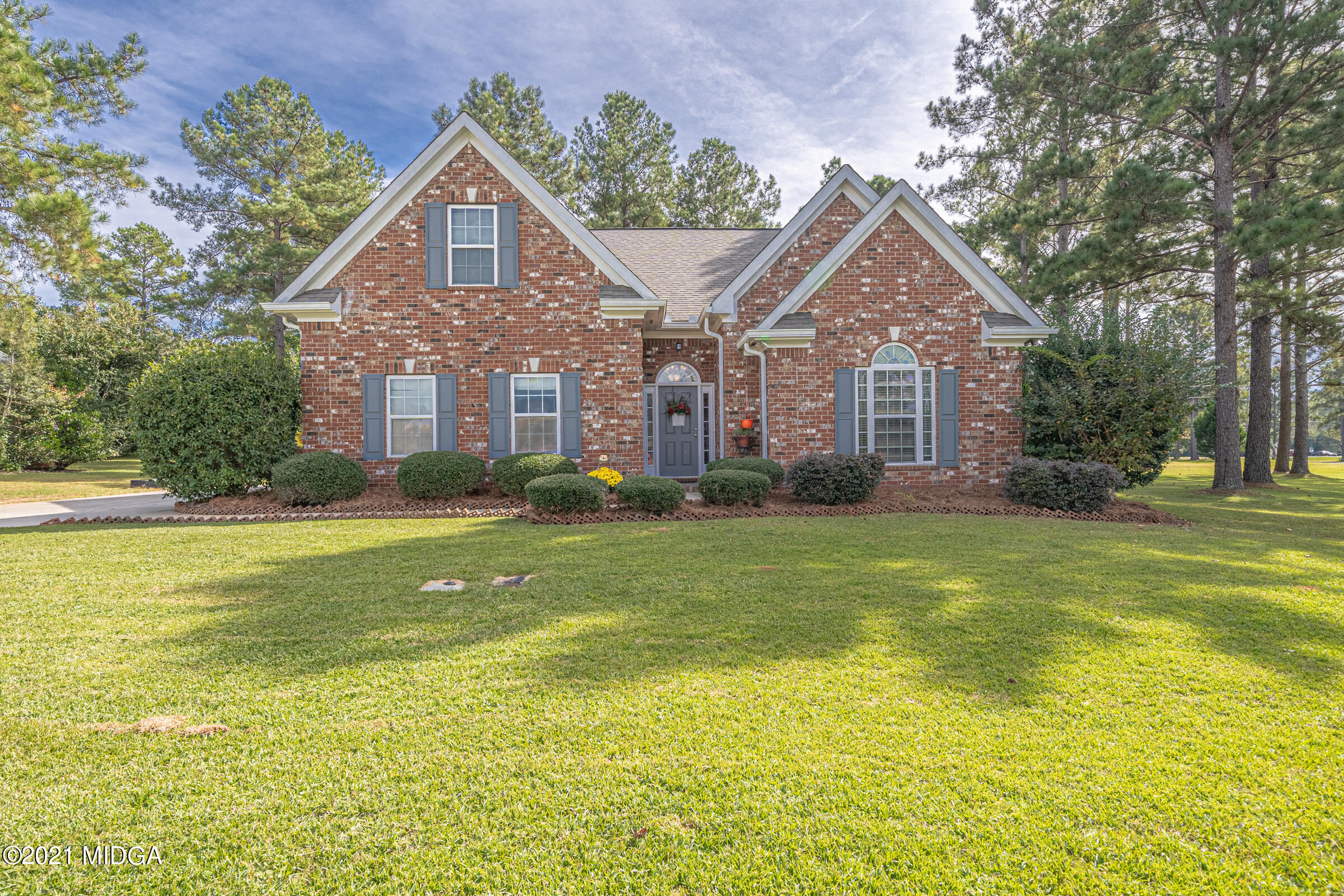 102 Bridgehampton Way Perry, GA 31069 - Photo 1 of 27 a front view of house with yard and swimming pool
