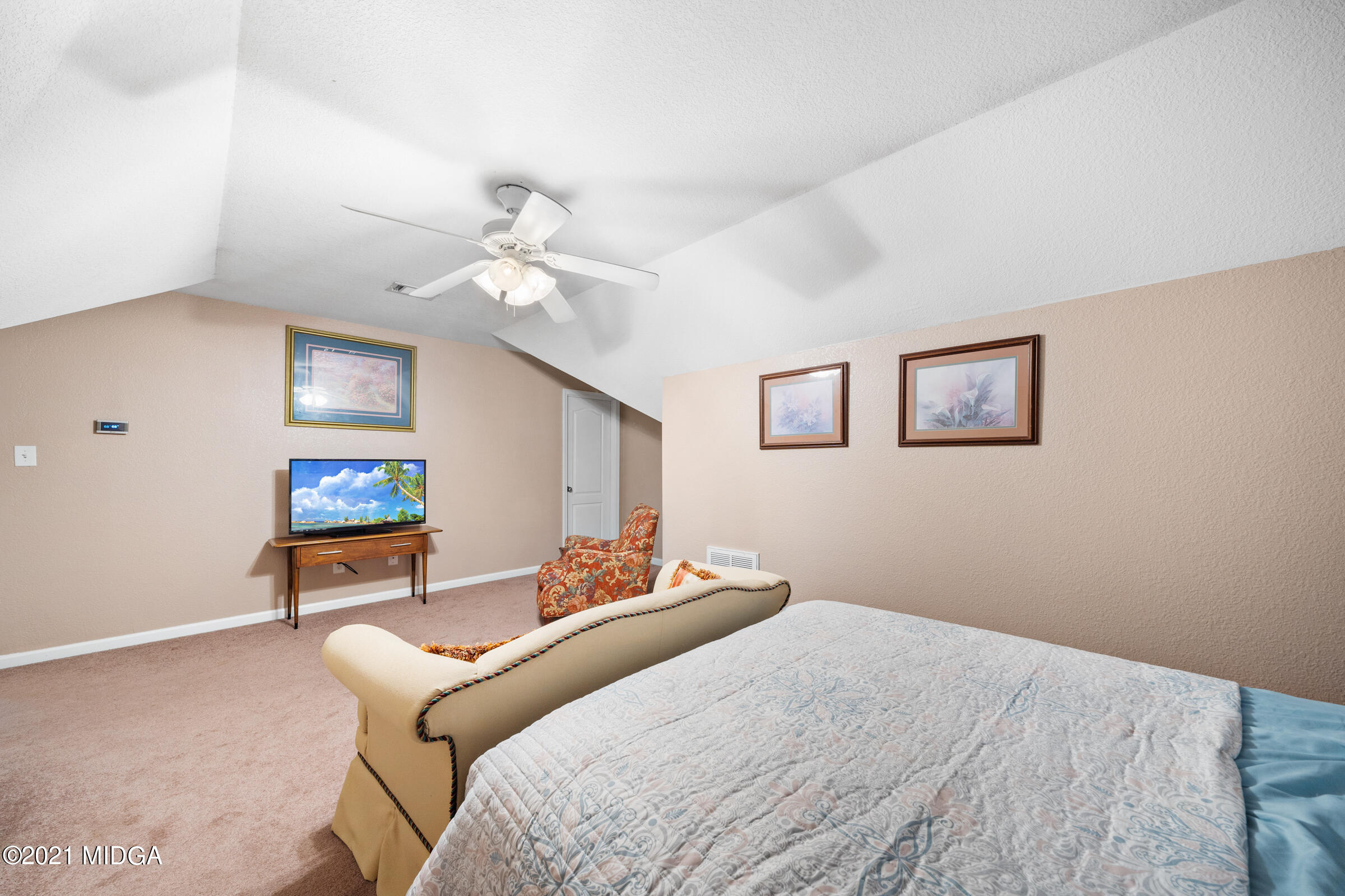 102 Bridgehampton Way Perry, GA 31069 - Photo 21 of 27 a bedroom with a large bed and a chandelier