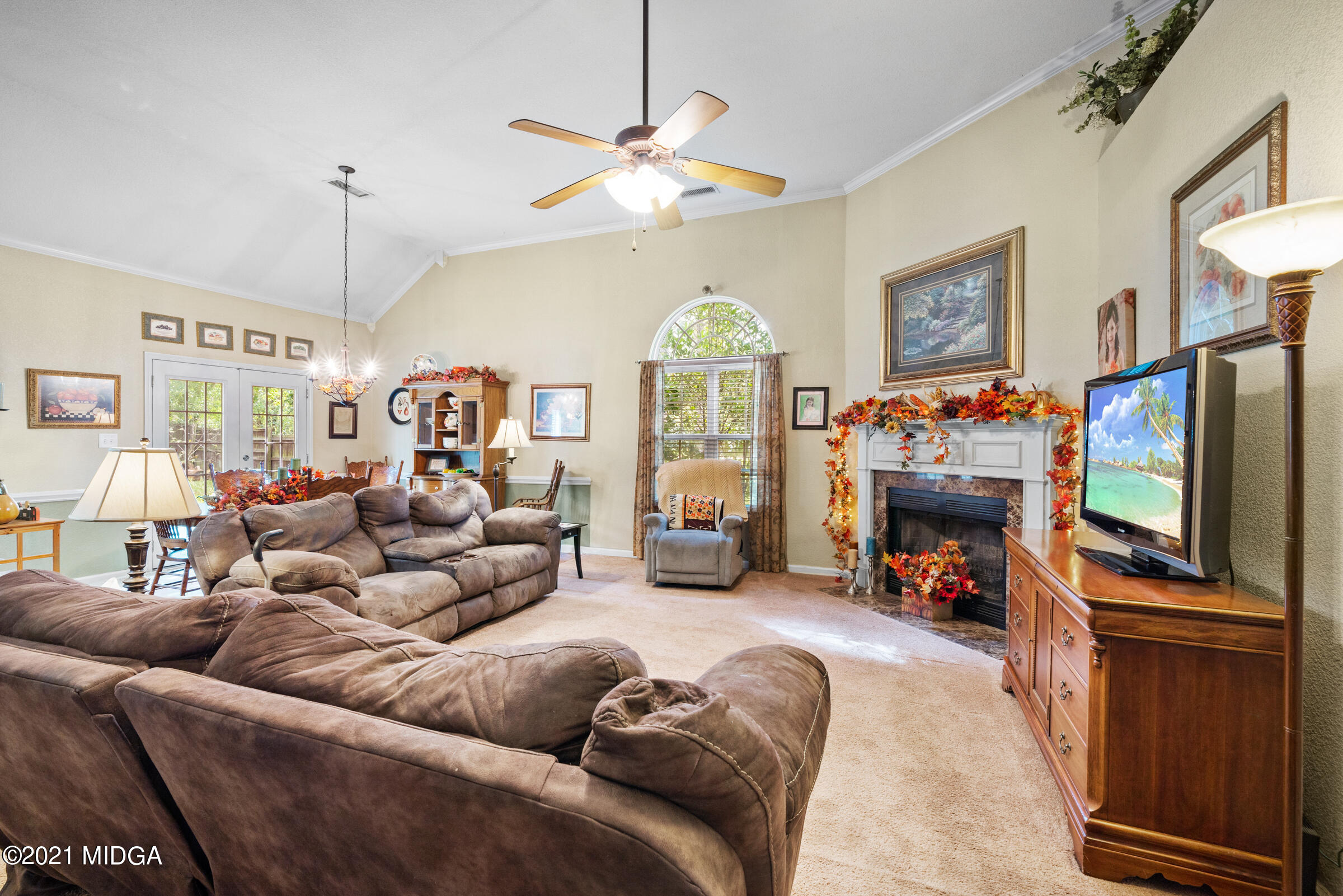102 Bridgehampton Way Perry, GA 31069 - Photo 7 of 27 a living room with furniture a fireplace and a flat screen tv