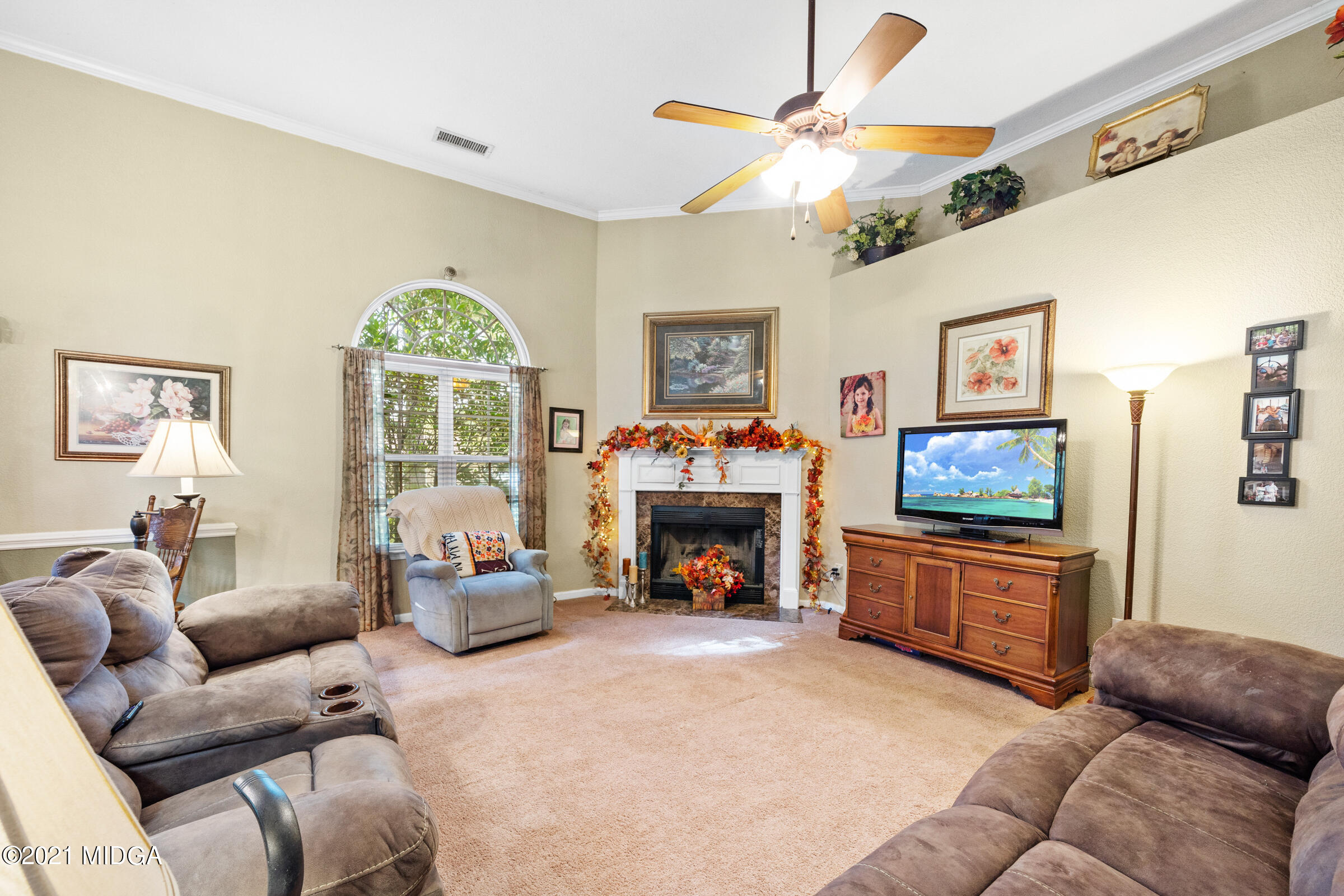 102 Bridgehampton Way Perry, GA 31069 - Photo 8 of 27 a living room with furniture a fireplace and a flat screen tv