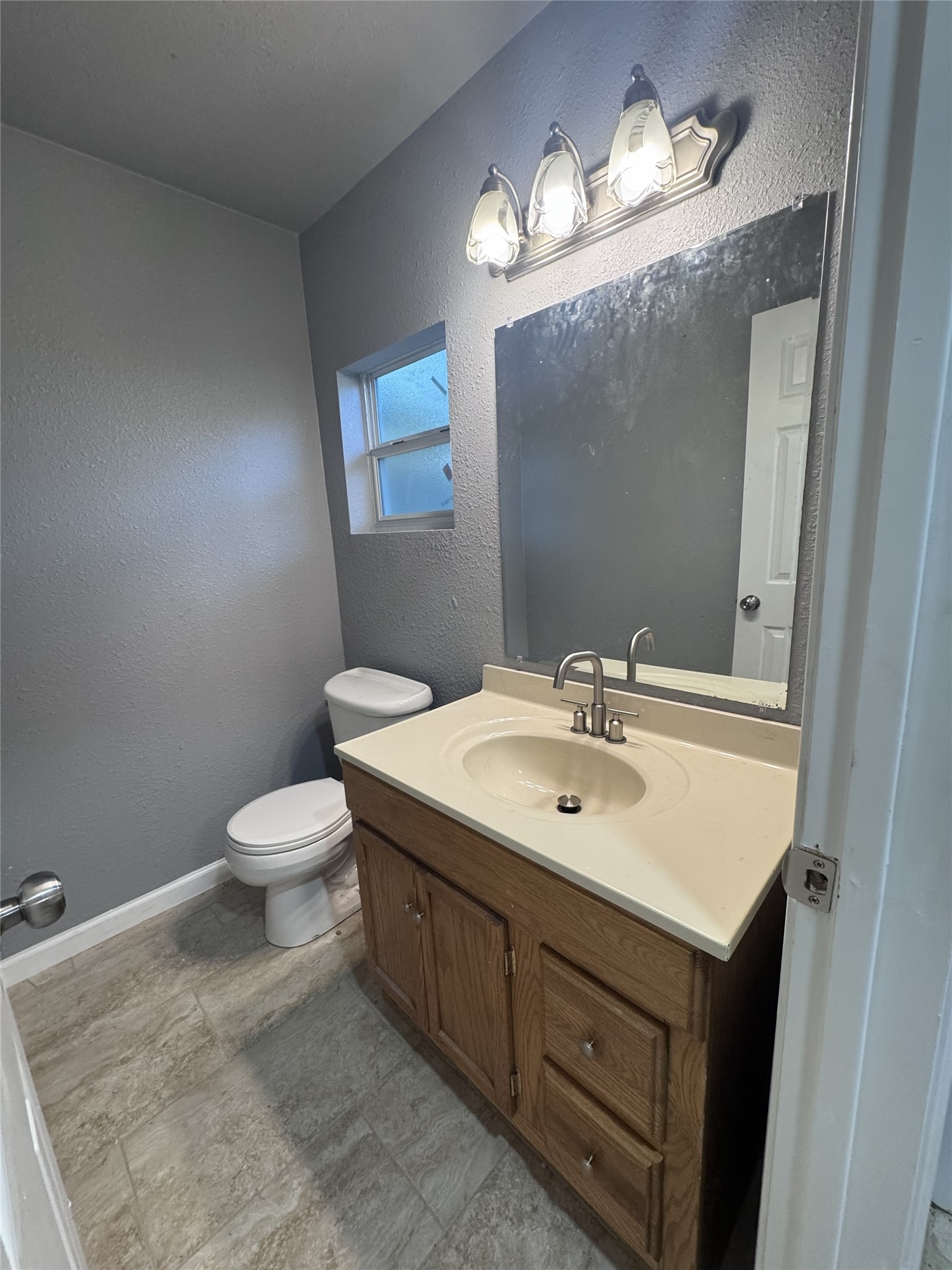 4933 Alvin Street Houston, TX 77033 - Photo 7 of 9 a bathroom with a sink toilet and mirror