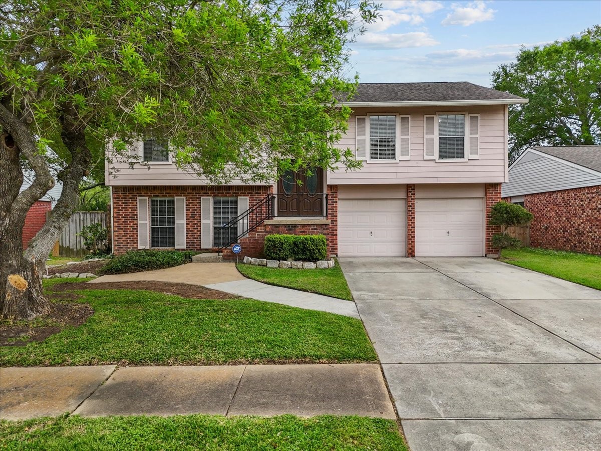 430 Redway Lane Houston, TX 77598 - Photo 35 of 43 a front view of a house with a yard and a garage