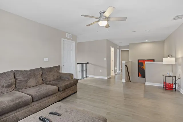 a work room with furniture and view of kitchen