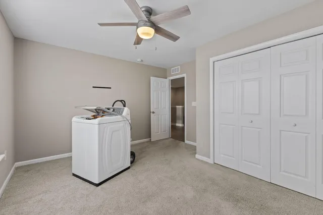 a bedroom with a bed and ceiling fan